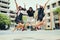 Three asian teenager jumping mid air with happiness emotion against school building background