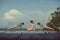 Three asian woman playing yoga flow on beach pier