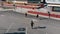 Three athletic young men running on the road and doing tricks. Aerial view