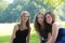 Three attractive happy young teenage girls sitting together