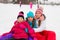 Three attractive skater girl sitting on the ice