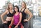 Three attractive women in sportswear posing in the gym