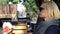 Three attractive young girls sit at an outdoor cafe and talk