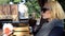 Three attractive young girls sit at an outdoor cafe and talk