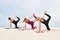 Three attractive young women perform yoga exercises