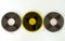 Three audio tapes on a reel of different colors, on a white background