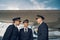 Three aviators having a conversation by a landed jetliner