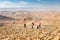 Three backpackers standing mountains trail , Negev desert, Israel