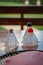 Three Badminton shuttles or birdies on a table outside with a racket, Blurry background