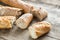 Three baguettes on the wooden background