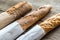 Three baguettes on the wooden background