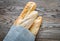 Three baguettes on the wooden background