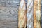 Three baguettes on the wooden background