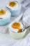 Three baked egg in ramekins on white background