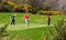 A three ball of budding young amateur golfers putting out on the 9th green of the Dufferin course at Clandeboye Northern Ireland