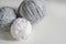 Three ball of wool yarn for knitting, gray ball of yarn, white ball of yarn on white background