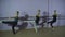 Three ballerinas Practicing At Ballet Barre In Dance Studio