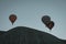 Three balloons fly over the mountain