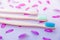 Three bamboo brushes on a purple background with petals