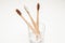 Three bamboo toothbrushes in a glass. Zero waste
