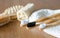 Three Bamboo toothbrushes with towel and eco natural plastic free luffa, wooden brushes on the background