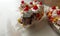 Three banana split sundaes on a faded white background, close up side view. Copy space.