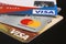 Three bank credit cards with Visa and Mastercard logos on a black background