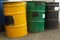 Three barrels in a row, yellow, green and black