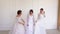 Three beauties in wedding dresses pose for the photographer.