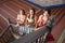Three beautiful adult belly dancers are looking up at the camera from the bottom of the stairs. The dancers are dressed in typical