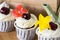 Three beautiful cakes with cherries and flowers on a teapot background with tea