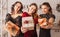 Three beautiful cheerful happy young girls friend laughing with gift at the christmas dining table on the background of the new