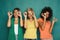 Three beautiful girls covering eyes with cucumber pieces