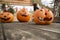 Three beautiful Halloween pumpkins on the table, each different, greeting customers