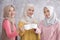 Three beautiful muslim woman cheers on their coffee for happy li