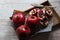 Three beautiful red pomegranates, pomegranates on a tray, pomegranate seeds, a colored napkin, pomegranate seeds