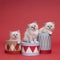 Three beautiful sacred burmese cat kittens sitting in and on boxes in studio close-up, luxury cat, red background