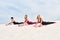 Three beautiful slender women perform bhujangasana yoga pose