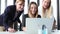 Three beautiful smiling businesswoman with laptop, high-fiving and cheering