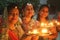 Three beautiful smiling ladies celebrate Diwali