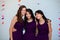 Three beautiful teen girls together in matching pruple dresses