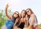 Three beautiful woman eating ice cream during selfie doing photo