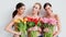 Three beautiful women with fresh spring tulips