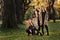 Three beautiful young models in autumn elegant clothes posing at Central Park.