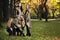 Three beautiful young models in autumn elegant clothes posing at Central Park.