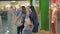 Three beautifull young girls holding shopping bags, taking picture, making selfie. Girls laughing and smiling at the