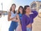 Three beauty women standing together on the street on a sunny day