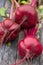 Three beetroot on the wooden table