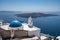 Three Bells of Fira in Santorini, with its characteristic blue dome located above the cliffs, Greece