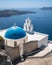 Three Bells of Fira in Santorini, with its characteristic blue dome located above the cliffs, Greece